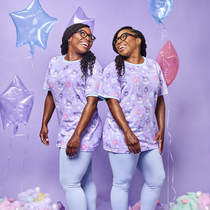 Set of female twins wearing the Kuromi Carnival Unisex Ringer Tee against a purple background with blue, purple, and pink balloons